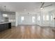 Spacious living room with wood floors, bright windows, and kitchen featuring pendant lighting nearby at 204 Wakehurst Way, Marietta, GA 30064