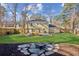 Large, landscaped backyard featuring a fire pit, well-maintained lawn, and a pergola at 2110 Laurel Mill Way, Roswell, GA 30076