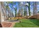 Spacious backyard featuring a pergola swing, deck, lawn, and fenced perimeter at 2110 Laurel Mill Way, Roswell, GA 30076