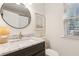 Modern bathroom features marble countertops, dark cabinetry, and stylish fixtures at 2110 Laurel Mill Way, Roswell, GA 30076
