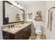 Granite countertop with double sinks, dark wood cabinets, and open shelving provide space and style at 2110 Laurel Mill Way, Roswell, GA 30076