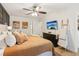 Cozy bedroom with a king bed, neutral decor, board and batten accent wall, ceiling fan, and wood floors at 2110 Laurel Mill Way, Roswell, GA 30076