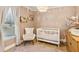 Charming Bedroom with a white crib, cozy chair, and bright natural light at 2110 Laurel Mill Way, Roswell, GA 30076