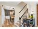 Inviting entryway with a staircase and view into the dining room with a light fixture at 2110 Laurel Mill Way, Roswell, GA 30076