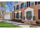 Close-up view of the front of a red brick home with tidy landscaping and an American flag at 2110 Laurel Mill Way, Roswell, GA 30076