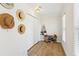 Bright hallway features a closet, wood floors, and decoratively displayed sun hats at 2110 Laurel Mill Way, Roswell, GA 30076