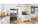 Well-equipped kitchen showcases modern appliances, plenty of cabinet space, and opens to the cozy dining area at 2110 Laurel Mill Way, Roswell, GA 30076