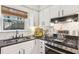 Bright kitchen featuring stainless steel appliances, granite countertops, white cabinets and a cozy breakfast nook at 2110 Laurel Mill Way, Roswell, GA 30076