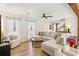 Open concept living room with a comfortable sectional sofa, wood beam and natural light at 2110 Laurel Mill Way, Roswell, GA 30076