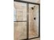 Modern shower featuring neutral toned tile, glass doors, and a rainfall shower head at 2110 Laurel Mill Way, Roswell, GA 30076