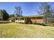 Expansive backyard featuring a charming screened porch and mature landscaping, perfect for outdoor entertaining at 4205 S Hurt Sw Rd, Smyrna, GA 30082