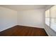 Bright, empty bedroom with hardwood floors, and a large window at 4205 S Hurt Sw Rd, Smyrna, GA 30082
