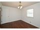 This is a quaint bedroom with hardwood floors, window, and overhead lighting fixture at 4205 S Hurt Sw Rd, Smyrna, GA 30082