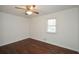 Bright bedroom features hardwood floors, a ceiling fan, and a window that lets in ample natural light at 4205 S Hurt Sw Rd, Smyrna, GA 30082