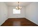 Dining room showcasing hardwood floors, decorative lighting fixture and large window at 4205 S Hurt Sw Rd, Smyrna, GA 30082