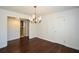 Dining room showcasing hardwood floors, decorative lighting fixture, large window and doorway to another room at 4205 S Hurt Sw Rd, Smyrna, GA 30082
