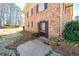 Charming brick home entrance with a unique front door, steps, and mature landscaping at 4205 S Hurt Sw Rd, Smyrna, GA 30082