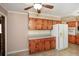 Traditional kitchen features wood cabinets, tile floor and countertops, and modern appliances at 4205 S Hurt Sw Rd, Smyrna, GA 30082