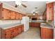 Traditional kitchen features wood cabinets, tile floor and countertops, and modern appliances at 4205 S Hurt Sw Rd, Smyrna, GA 30082