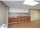 Basement kitchenette features a sink and wood cabinets beneath a drop ceiling at 4205 S Hurt Sw Rd, Smyrna, GA 30082