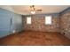 Spacious living room featuring a carpet, brick wall and natural light at 4205 S Hurt Sw Rd, Smyrna, GA 30082