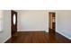 Open living room space with hardwood flooring, natural light, and a view into the kitchen at 4205 S Hurt Sw Rd, Smyrna, GA 30082