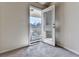 Carpeted room that opens to a balcony overlooking the neighborhood at 426 Parkstone Dr, Woodstock, GA 30188