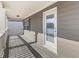 Exterior view of a railed, covered, wooden balcony with a glass door at 426 Parkstone Dr, Woodstock, GA 30188