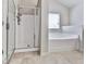 Bright bathroom showcasing separate glass door shower and a relaxing soaking tub at 426 Parkstone Dr, Woodstock, GA 30188
