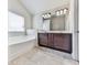 Bathroom featuring a double sink vanity, tile floor, and a soaking tub at 426 Parkstone Dr, Woodstock, GA 30188
