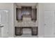 Office area with cabinets, drawers, granite countertop and mosaic backsplash at 426 Parkstone Dr, Woodstock, GA 30188
