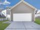 Two-car garage with a white door and grey siding, complementing the house's exterior at 426 Parkstone Dr, Woodstock, GA 30188