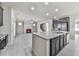 Open floor plan featuring a granite island, dark cabinets, a stainless steel refrigerator, and a fireplace at 426 Parkstone Dr, Woodstock, GA 30188