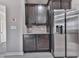 Kitchen with dark cabinets, granite countertop, stainless steel refrigerator and mosaic backsplash at 426 Parkstone Dr, Woodstock, GA 30188