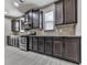 Kitchen features dark cabinets, granite countertops, tile backsplash and stainless steel appliances at 426 Parkstone Dr, Woodstock, GA 30188