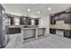 Stylish kitchen featuring stainless steel appliances, dark cabinets, and expansive island at 426 Parkstone Dr, Woodstock, GA 30188