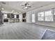 Open-concept living room featuring fireplace, wood-look floors, and abundant natural light at 426 Parkstone Dr, Woodstock, GA 30188
