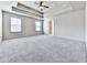 Spacious main bedroom with a tray ceiling, ceiling fan, and neutral carpet at 426 Parkstone Dr, Woodstock, GA 30188