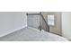Carpeted staircase with dark metal railing and a window allowing natural light at 426 Parkstone Dr, Woodstock, GA 30188
