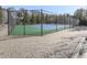 Community tennis court, featuring green and blue surfaces, surrounded by a secure fence at 426 Parkstone Dr, Woodstock, GA 30188