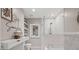 Modern bathroom with white tile, a glass-enclosed shower, and stylish decor at 4364 Grove Field Ct, Suwanee, GA 30024