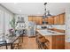 Bright kitchen featuring an island with seating, stainless steel appliances, and hardwood floors at 4364 Grove Field Ct, Suwanee, GA 30024