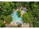 Aerial view of community pool with mature trees and plenty of seating around the pool area at 603 Dunbar Dr, Dunwoody, GA 30338
