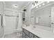 Bright bathroom showcasing a tub and shower combination, storage cabinets, and sleek gray vanity at 603 Dunbar Dr, Dunwoody, GA 30338