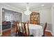 Formal dining room with a wooden table, chairs, chandelier, and view to living room at 603 Dunbar Dr, Dunwoody, GA 30338