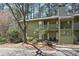 Exterior view of the two-story building with green siding, balconies, and a landscaped yard at 603 Dunbar Dr, Dunwoody, GA 30338