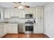 Well-lit kitchen with stainless steel appliances, granite countertops, and ample cabinet space at 603 Dunbar Dr, Dunwoody, GA 30338