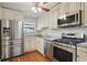Updated kitchen with stainless steel appliances, granite countertops, and ample cabinet space at 603 Dunbar Dr, Dunwoody, GA 30338