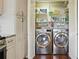 Convenient laundry room with modern washer and dryer, shelving and ample storage at 603 Dunbar Dr, Dunwoody, GA 30338