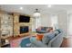 Inviting living room with a stone fireplace, built-in shelving, and cozy blue couches at 603 Dunbar Dr, Dunwoody, GA 30338